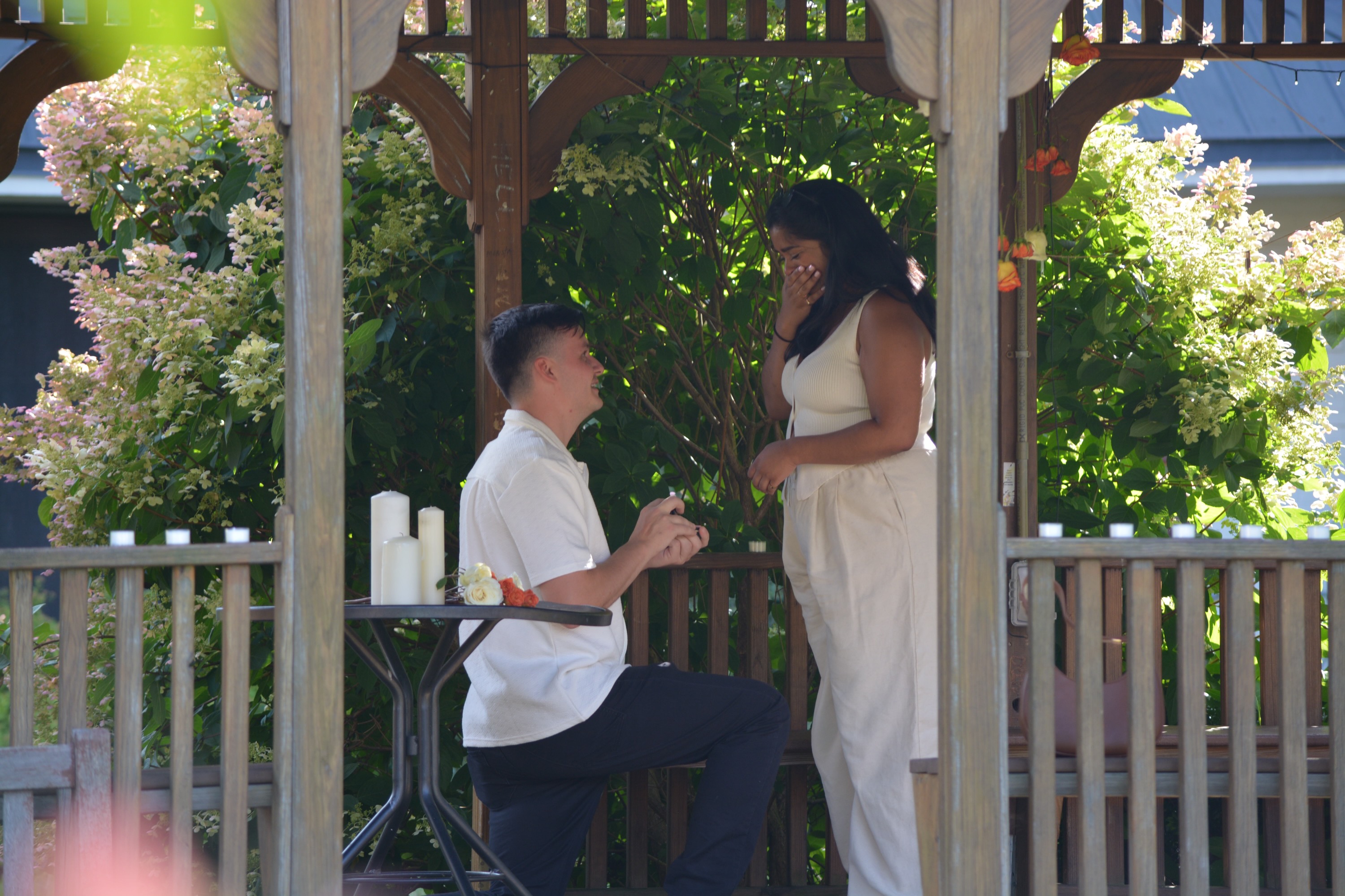 The proposal — Brendan on one knee in the gazebo