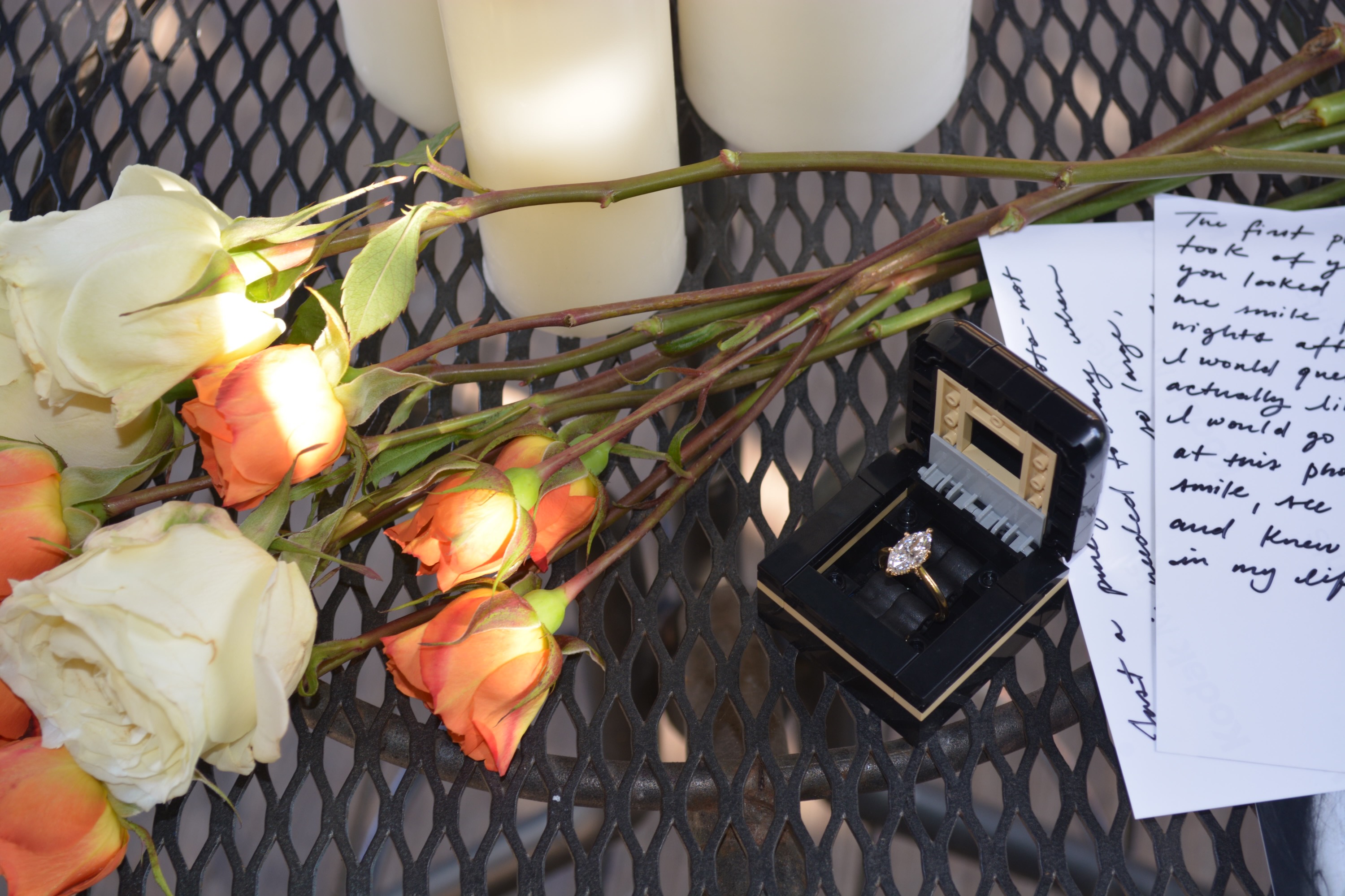 The ring — in its box with white and peach roses